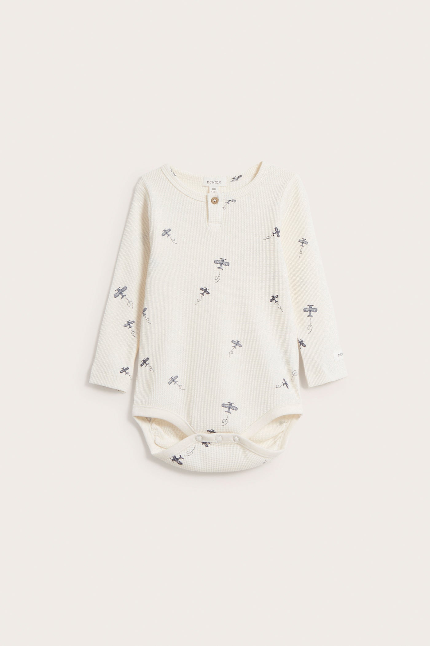 Baby white waffle-textured airplane bodysuit