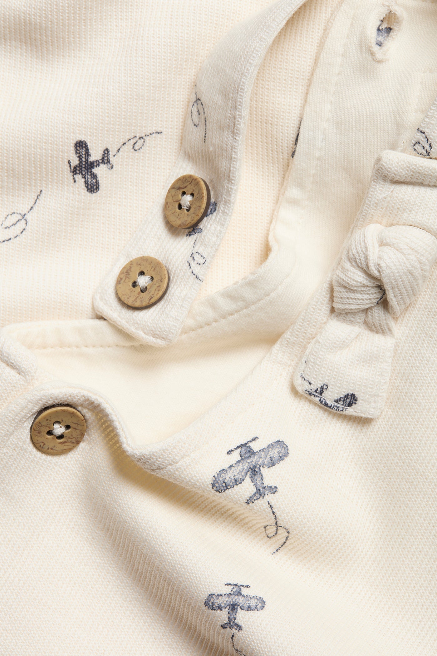 Baby white airplane patterned overalls