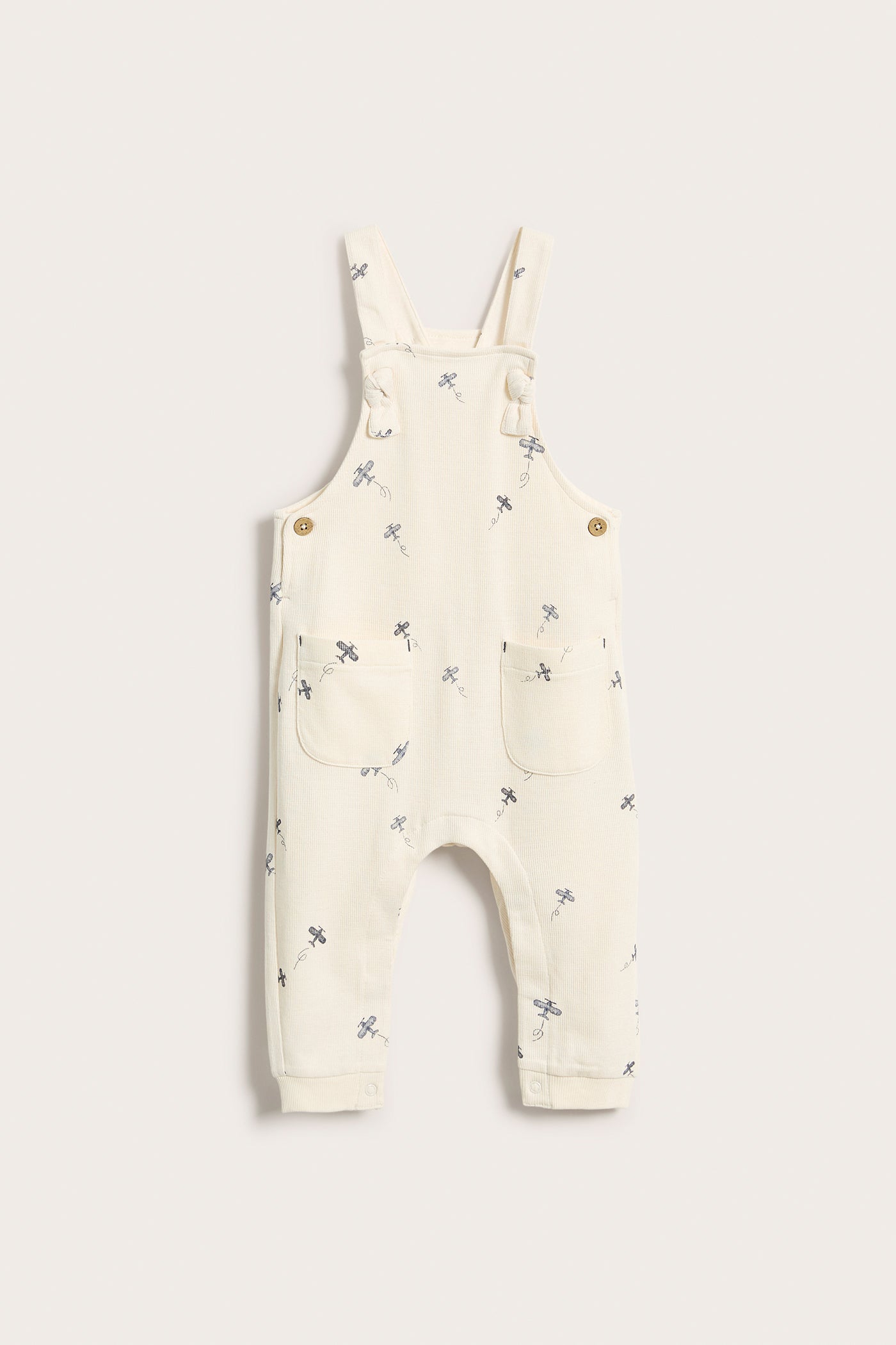 Baby white airplane patterned overalls