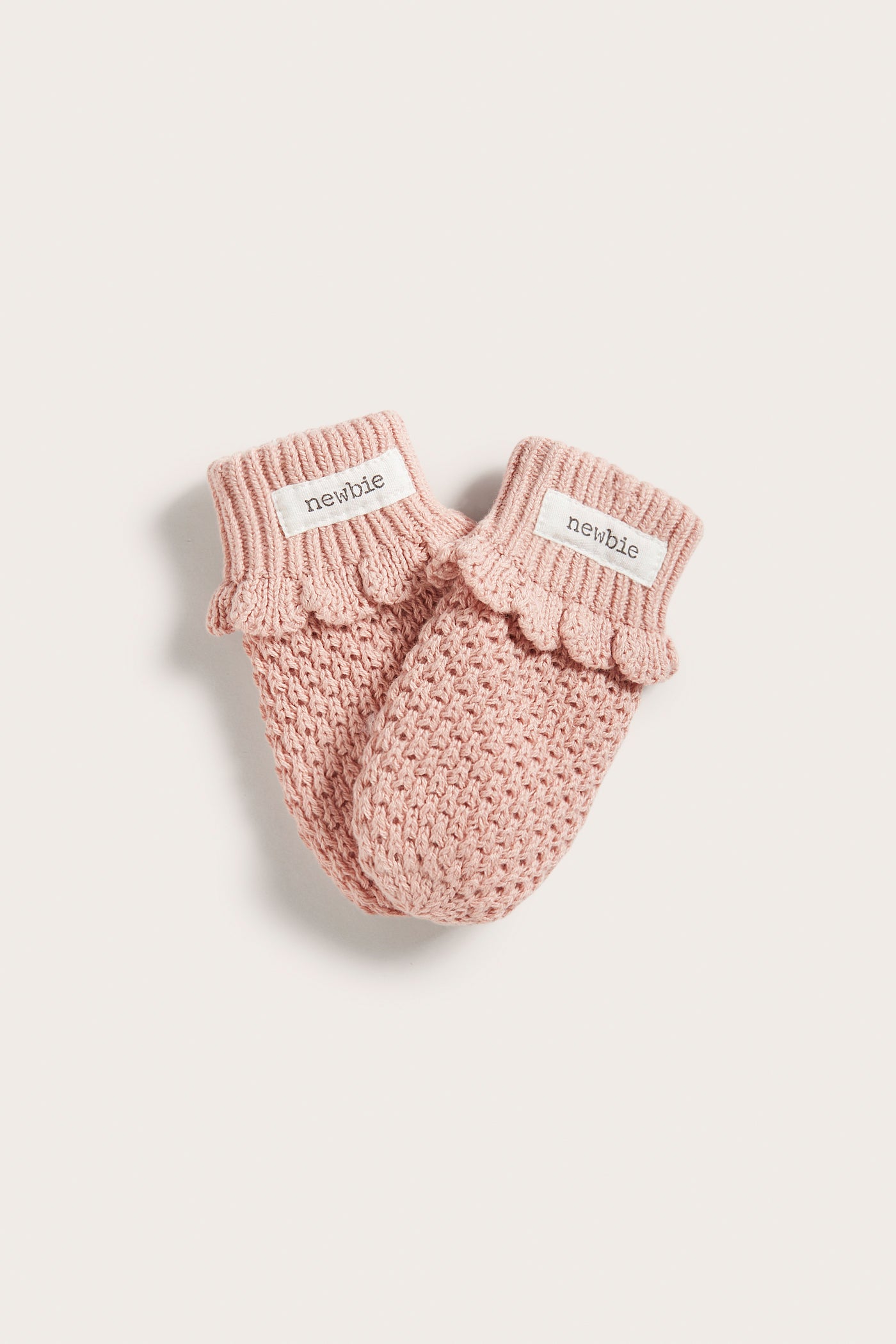 Baby pink knitted mittens