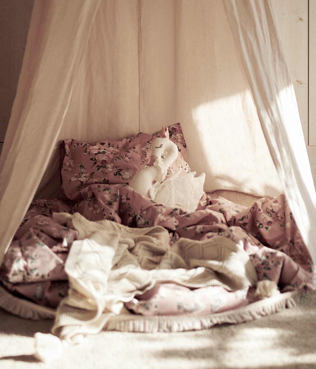 Beige reading tent with pom poms